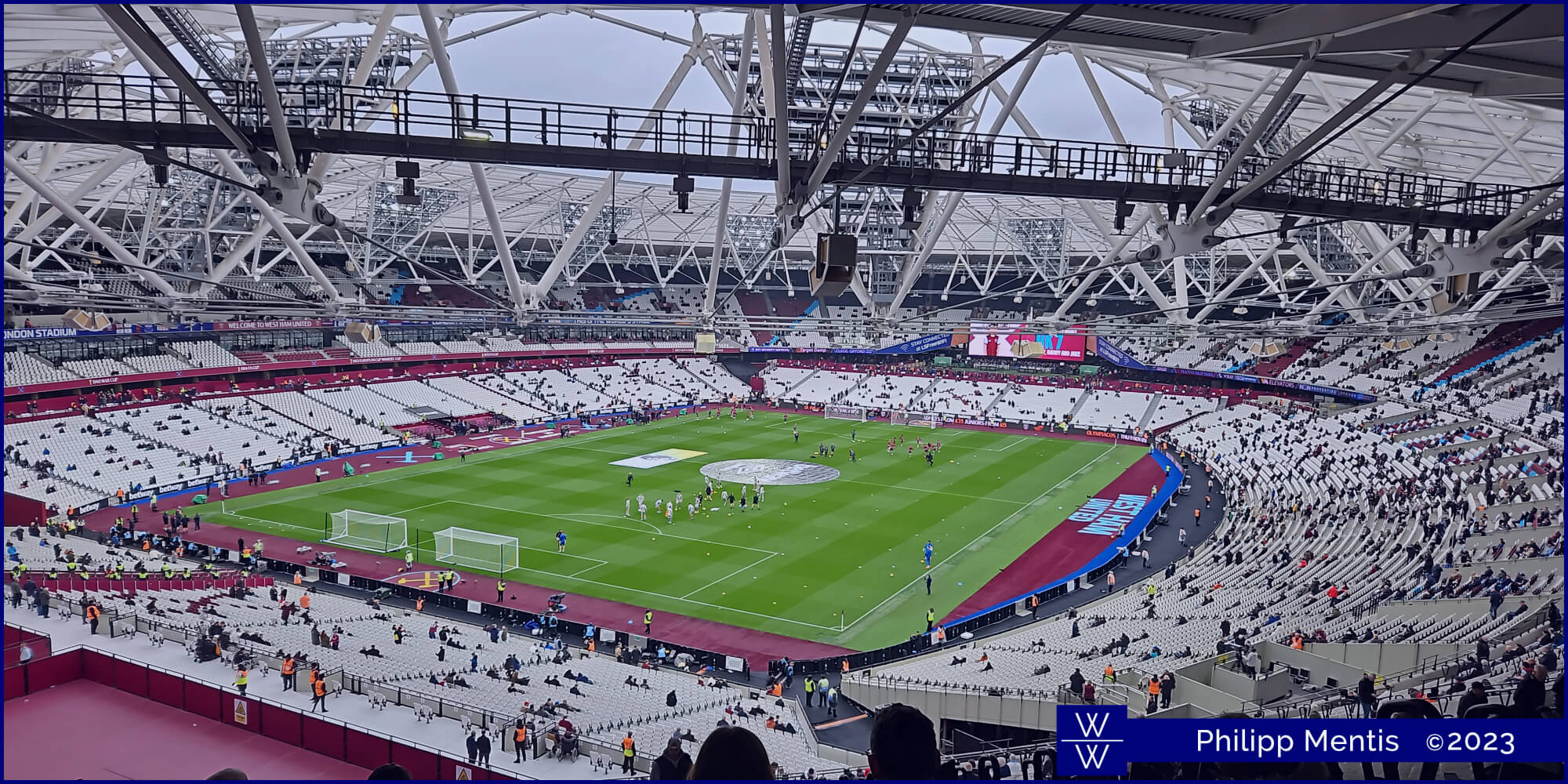 !B The insides of London Stadium. Curved seating and an immaculate green pitch.